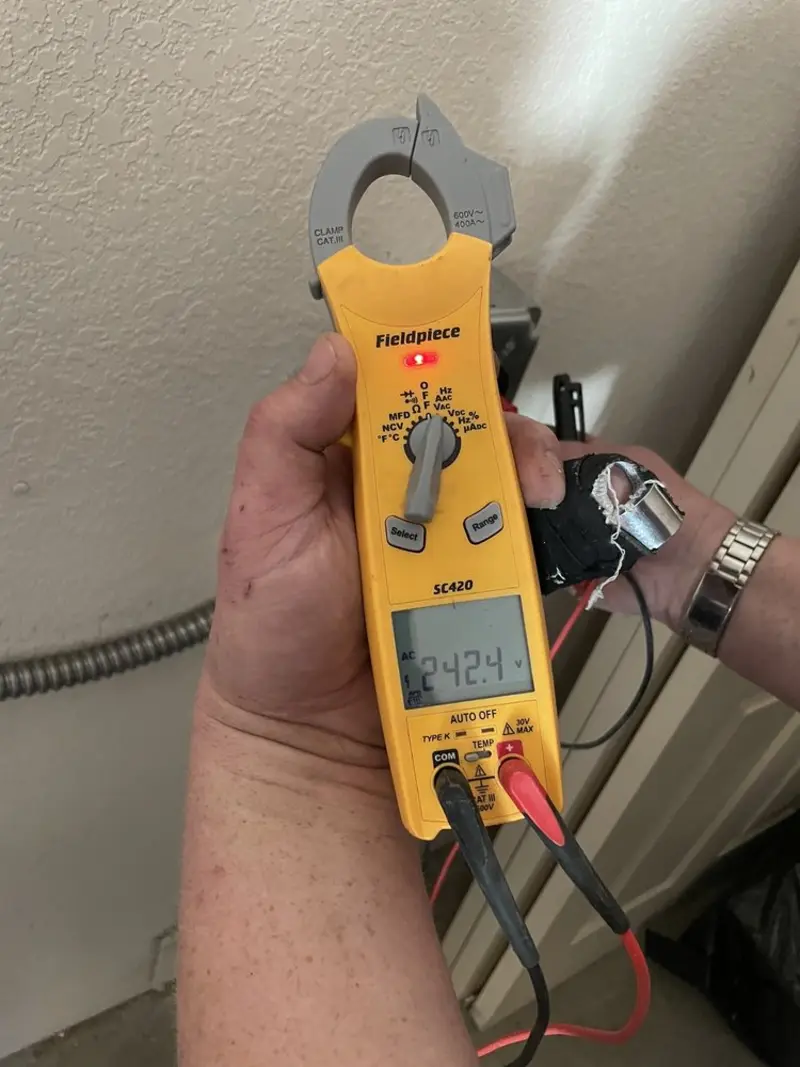 Voltage testing with clamp meter during Recessed Lighting Installation in Houston